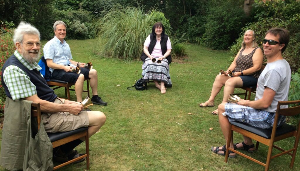 Ringing handbells on the lawn in hot weather